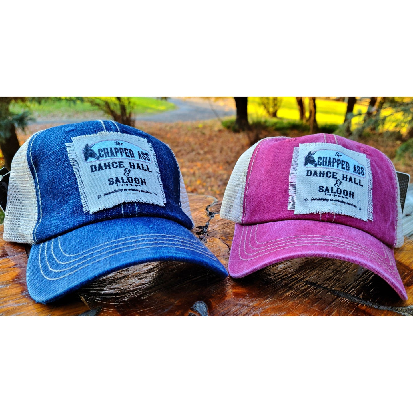 Red and blue Trucker hats featuring the chapped ass dance hall and saloon with a donkey on it