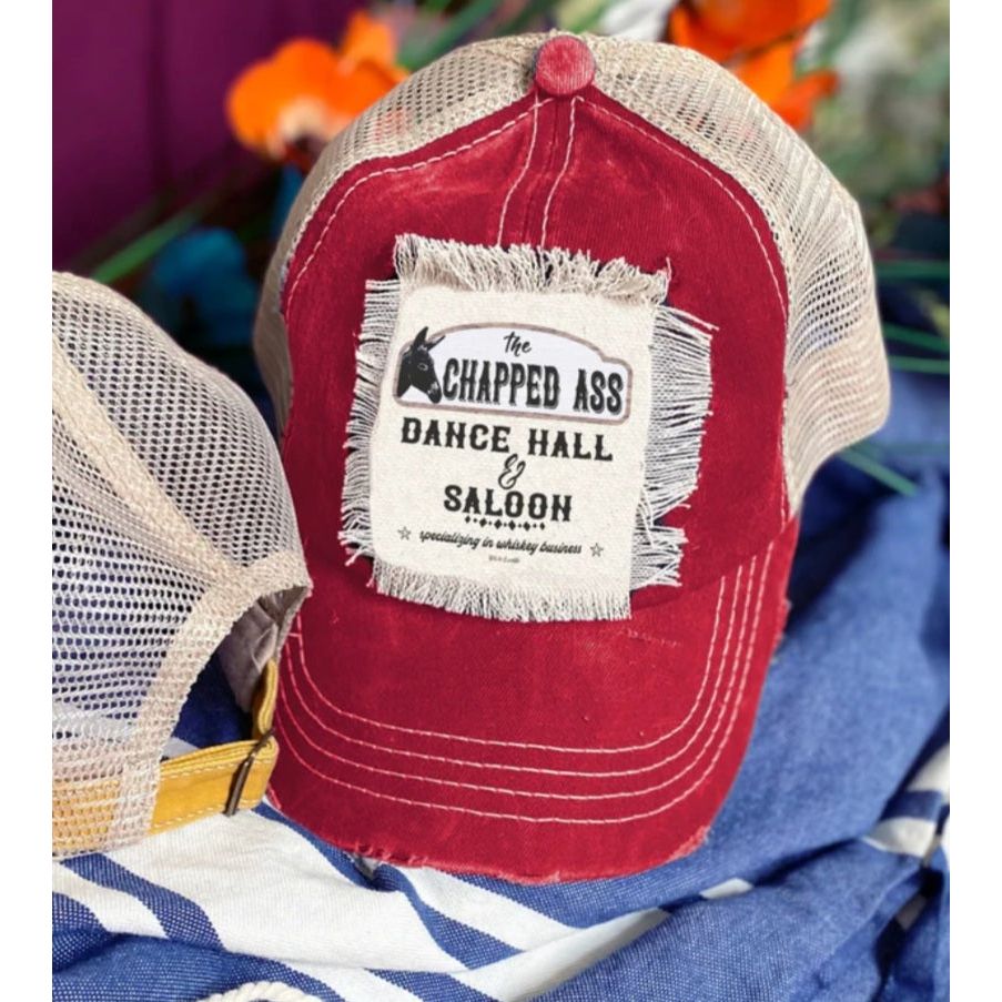 Red Trucker hat featuring the chapped ass dance hall and saloon with a donkey on it